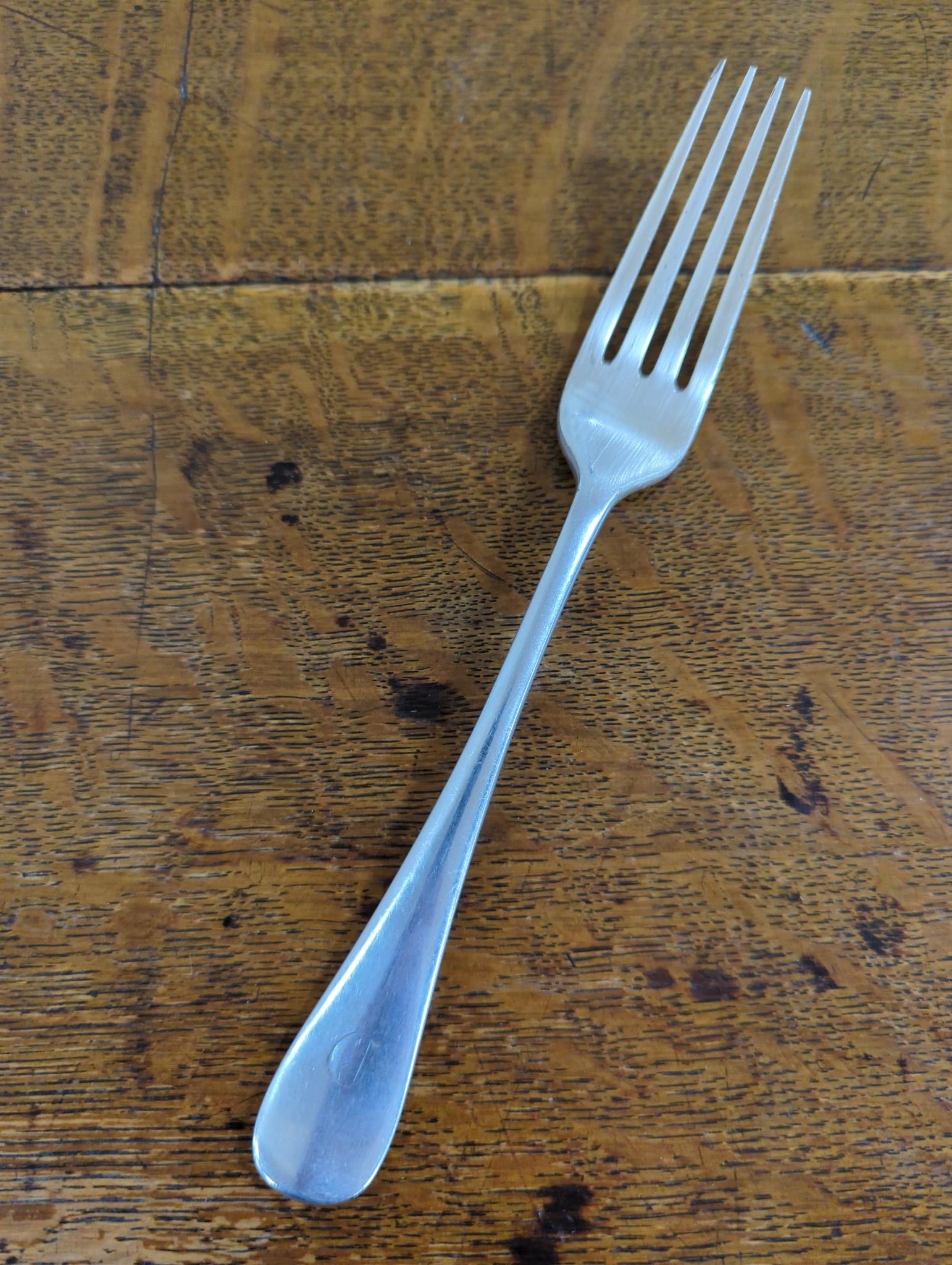 An Edwardian oak cased silver plated table canteen, settings for twelve and a set of silver plated fish knives and forks for twelve